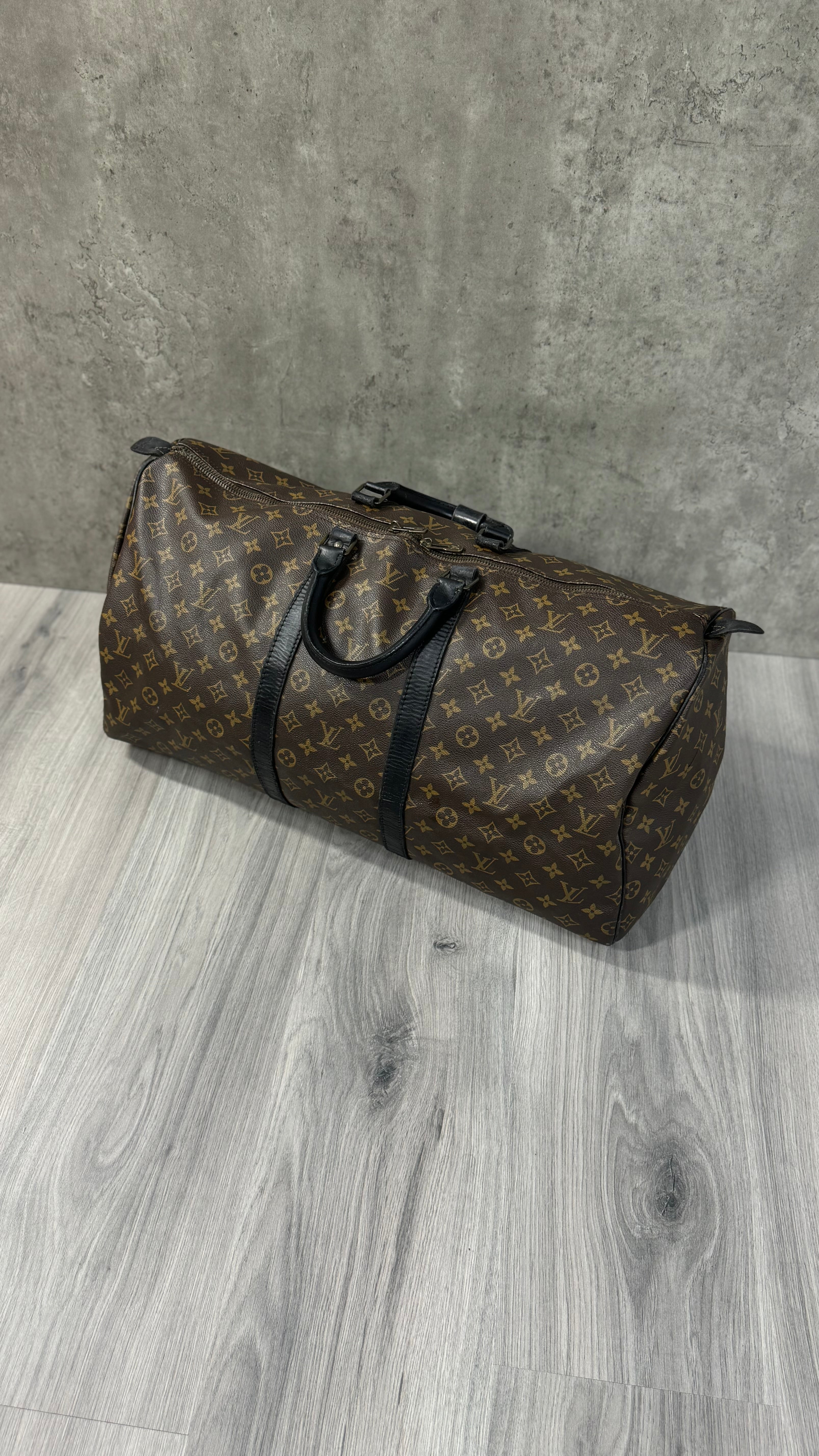 Louis Vuitton Keepall Bandoulière 55 in Monogram Macassar canvas with black leather trim