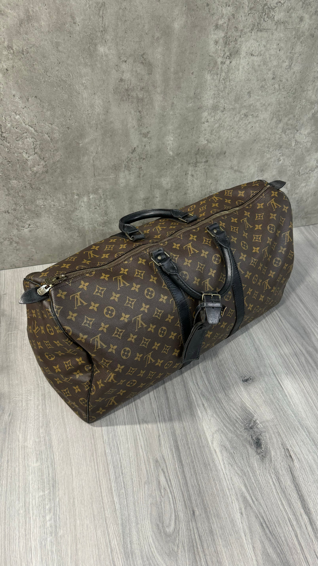 Louis Vuitton Keepall Bandoulière 55 in Monogram Macassar canvas with black leather trim