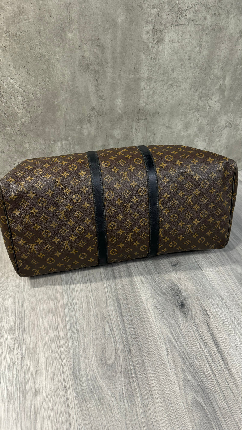 Louis Vuitton Keepall Bandoulière 55 in Monogram Macassar canvas with black leather trim