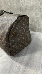 Louis Vuitton Keepall Bandoulière 55 in Monogram Macassar canvas with black leather trim