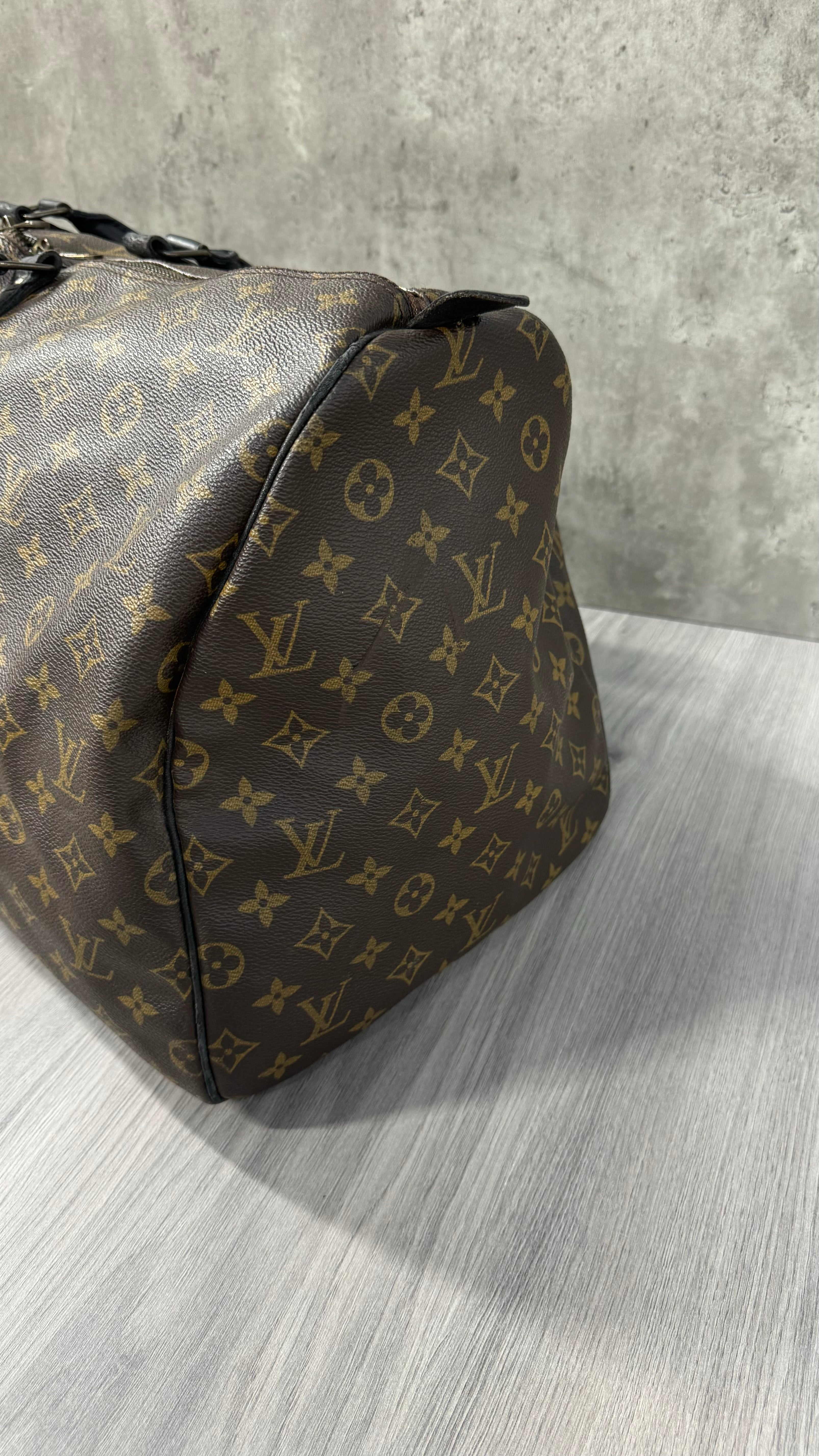 Louis Vuitton Keepall Bandoulière 55 in Monogram Macassar canvas with black leather trim