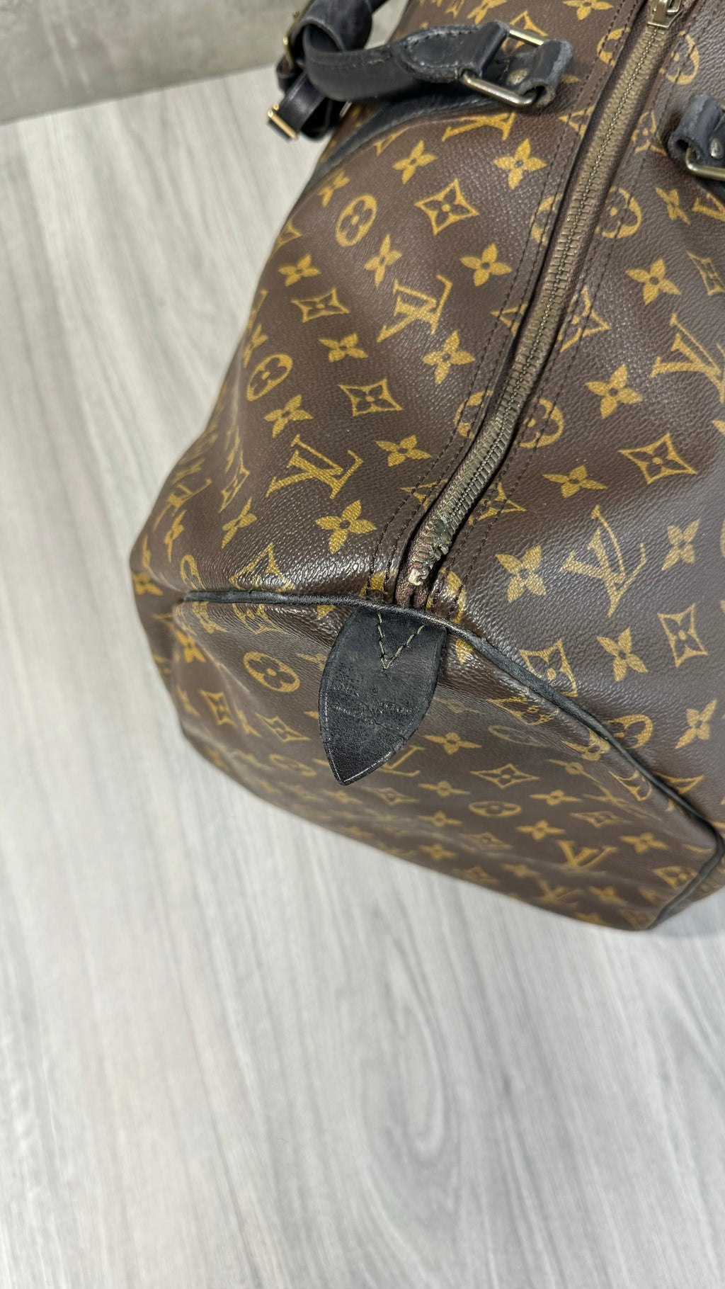 Louis Vuitton Keepall Bandoulière 55 in Monogram Macassar canvas with black leather trim