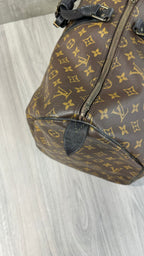 Louis Vuitton Keepall Bandoulière 55 in Monogram Macassar canvas with black leather trim