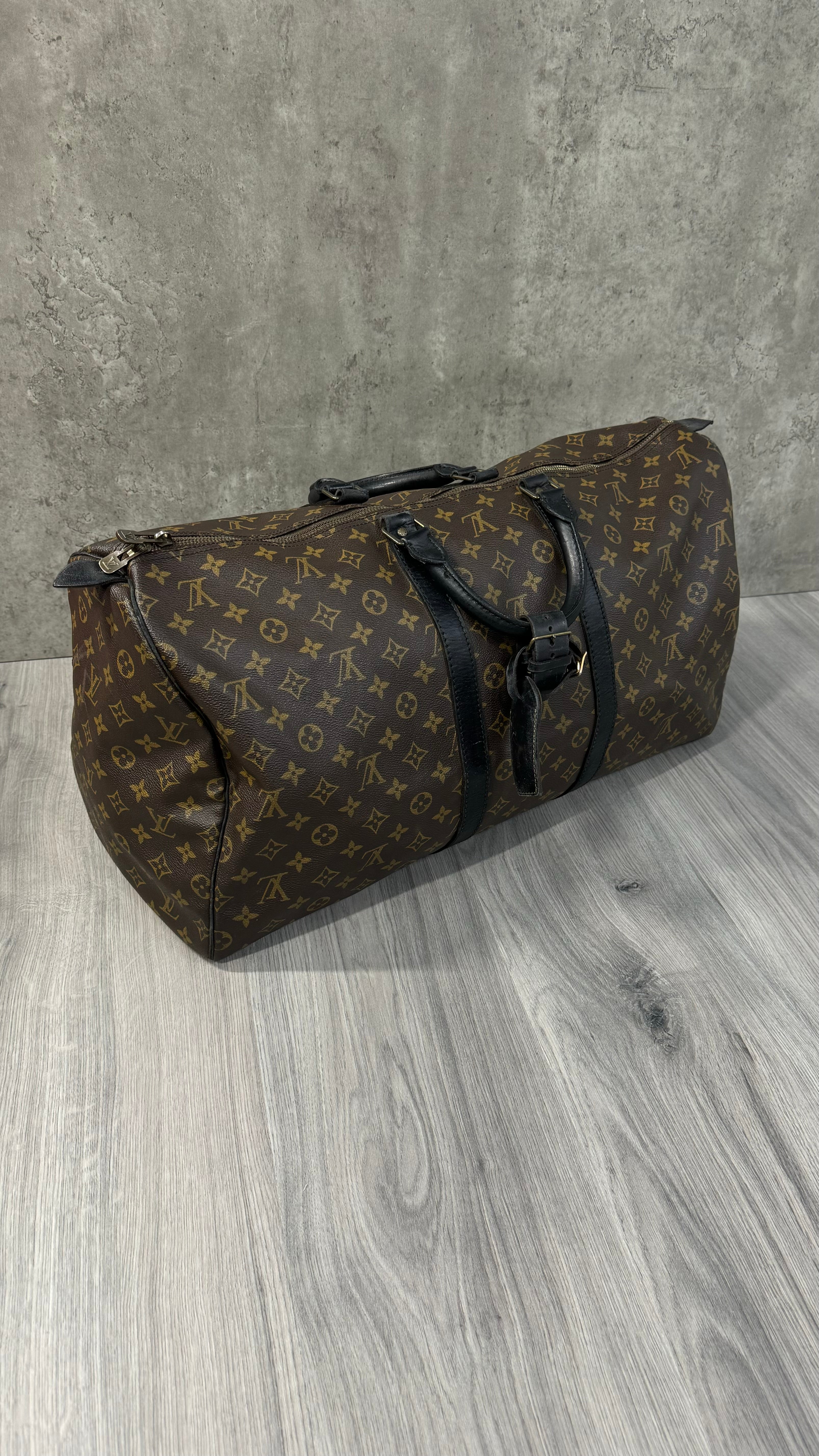 Louis Vuitton Keepall Bandoulière 55 in Monogram Macassar canvas with black leather trim