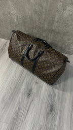 Louis Vuitton Keepall Bandoulière 55 in Monogram Macassar canvas with black leather trim