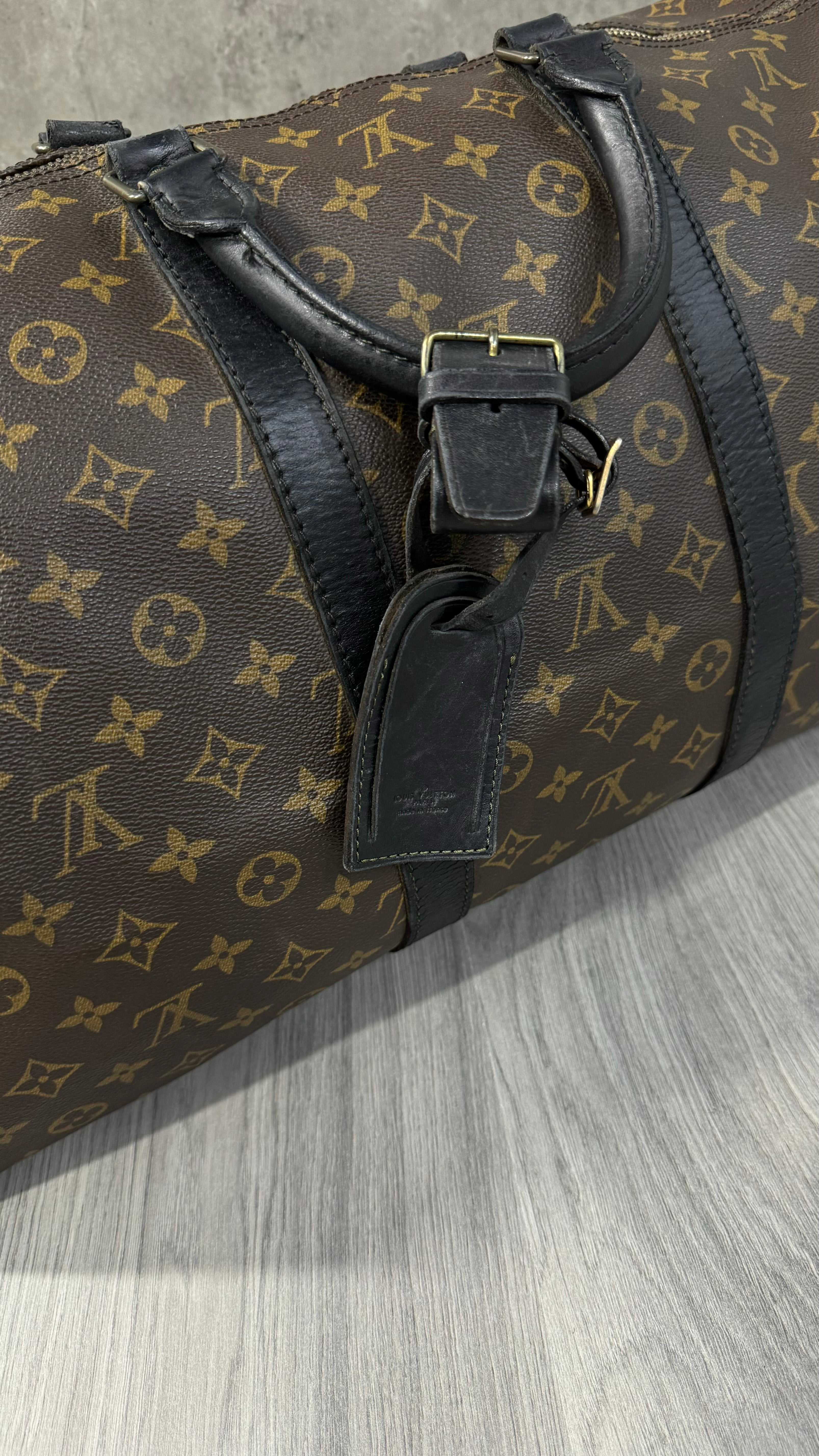 Louis Vuitton Keepall Bandoulière 55 in Monogram Macassar canvas with black leather trim