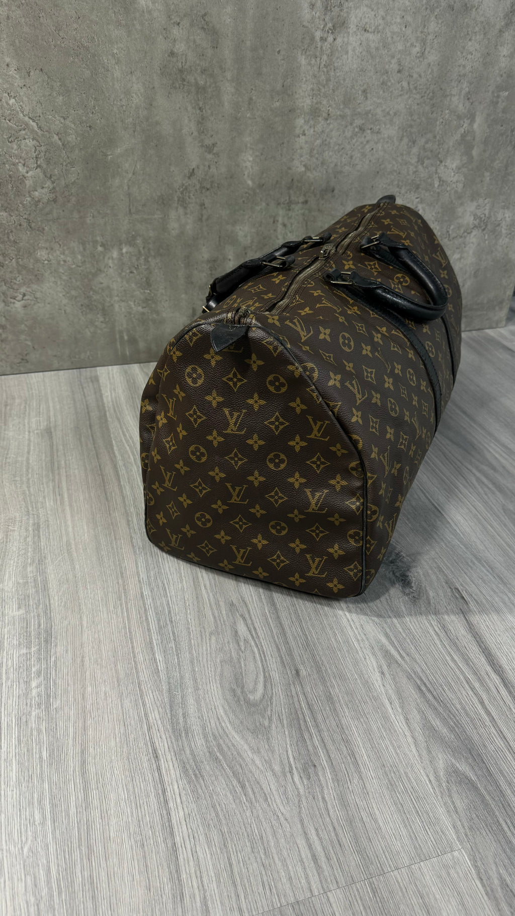 Louis Vuitton Keepall Bandoulière 55 in Monogram Macassar canvas with black leather trim