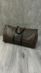 Louis Vuitton Keepall Bandoulière 55 in Monogram Macassar canvas with black leather trim